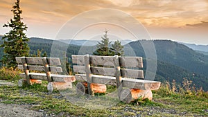 Benches on the Feldberg with a view over hazy hills.