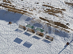 Benches and Footprints in the Snow at Burana Tower near Tokmok, Kyrgyzstan