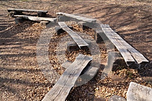 Benches from halved wooden logs in the forest