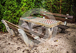 Benches in park with a table for a game in chess