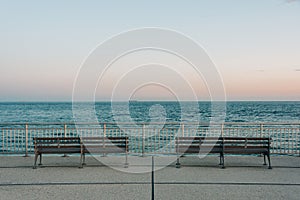 Benches on the Rockaways Boardwalk and view of the beach, in Queens, New York City