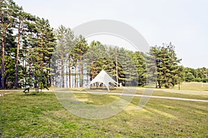 Benches and white tent from the sun at the lake