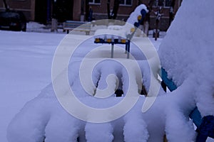 Benches in the yard covered with snow
