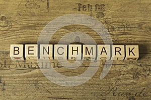 Benchmark word on a wooden cubes on a wooden background