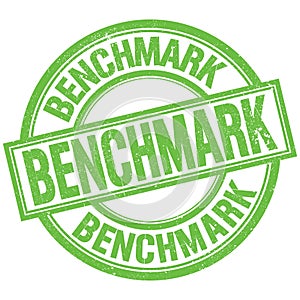 BENCHMARK written word on green stamp sign