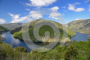 Bend of the river on a background of blue sky