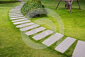 Bending garden stone path at night with glowing light from garden outdoor light