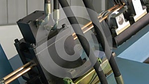 Bending of metal copper tubes on industrial machine in factory.