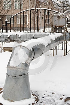 Bending of a metal pipe of a heating main, lightly covered with snow