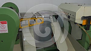 Bending of metal tubes on industrial CNC machine in factory.