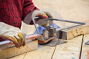 Worker using bending rebar machine for reinforcement in the construction work