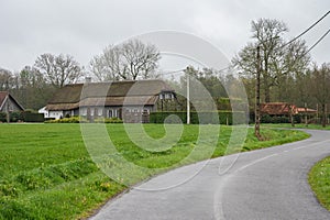 Bending road through the agriculture fields and farms, Geel, Belgium