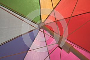 Beneath a brightly colored umbrella