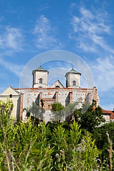 The Benedictine Abbey in Tyniec with wisla river on blue sky background