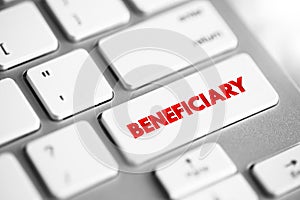Beneficiary - person or other legal entity who receives money or other benefits from a benefactor, text concept button on keyboard photo