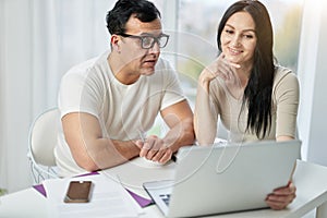 Benefits of online courses. Happy hispanic couple, man and woman making video call, talking on webcam while contacting