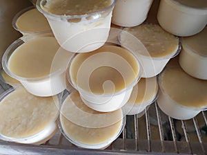 Bengal`s famous yogurt `mishti doi` is kept in some plastic cup photo