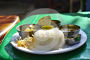 Bengali food thali with rice chips and vegetables