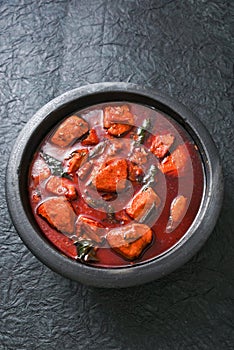 Bengali red fish curry in clay pot, Indian fish curry