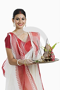 Bengali woman holding a puja thali photo