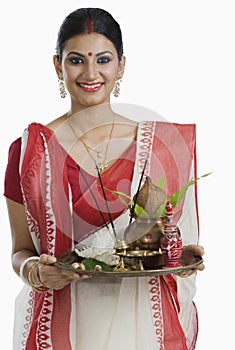 Bengali woman holding a puja thali photo