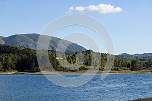 BeniarrÃ©s reservoir with the Almudaina mountain range in the background photo