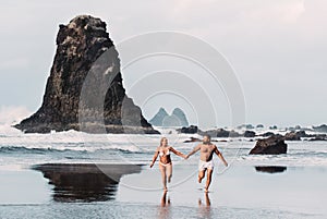 Benijo, Tenerife, Spain : Natural sand beach. Popular place for local people and tourists. Volcanic rocks billowi out of turquoise