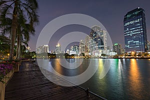 Benjakitti park and buildings in Bangkok at dusk photo