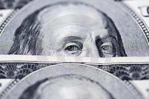 Benjamin Franklin`s eyes from a hundred-dollar bill