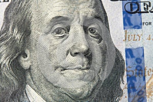 Benjamin Franklin's face on the US 100 dollar bill. Franklin on one hundred dollar. Detail of Portrait on One Hundred Dollar