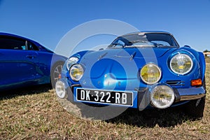 Old blue Renault Alpine A110,car exhibited at the tour de france in small village contryside