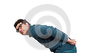 Bent down businessman carrying an heavy invisible object on his back isolated on white background. Overloaded business person