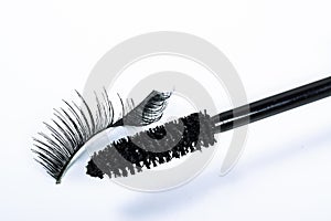 Bent false eyelash and a mascara brush