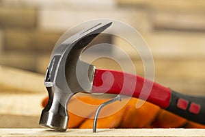 The bent nail sits on a hammer, a metalwork workshop