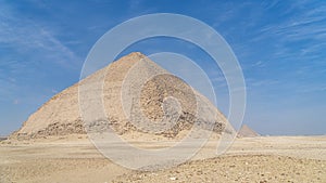 The Bent Pyramid is an ancient Egyptian pyramid located at the royal necropolis of Dahshur, approximately 40 kilometres south of