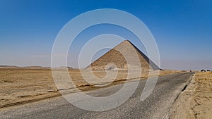 The Bent Pyramid is an ancient Egyptian pyramid located at the royal necropolis of Dahshur, approximately 40 kilometres south of