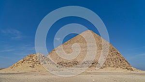 The Bent Pyramid is an ancient Egyptian pyramid located at the royal necropolis of Dahshur, approximately 40 kilometres south of