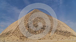 The Bent Pyramid is an ancient Egyptian pyramid located at the royal necropolis of Dahshur, approximately 40 kilometres south of