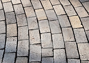 Bent rows of grey cobble pavement