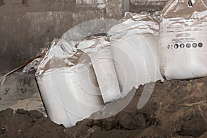 Bentonite clay powder packed in bags at an industrial plant for processing sand, soil and land