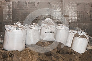 Bentonite clay powder packed in bags at an industrial plant for processing sand, soil and land