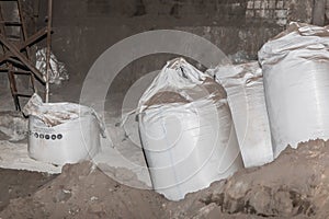 Bentonite clay powder packed in bags at an industrial plant for processing sand, soil and land