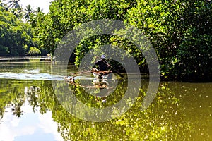 Bentota river with silhuette of fisherman at sunny day