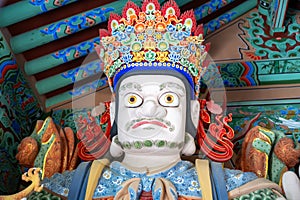 Beomeosa temple guard. A colorful painted statue in entrance door in Busan, South Korea. photo