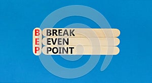 BEP break even point symbol. Concept words BEP break even point on wooden stick on a beautiful blue table blue background.