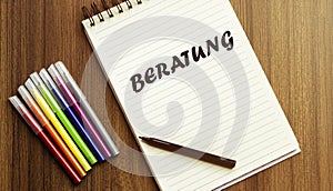 Beratung . your future target searching, a marker, pen, three colored pencils and a notebook for writing