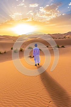 Berber man wearing traditional clothes in the Sahara Desert at dawn, Morocco