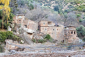 Berber village by river in Atlas mountains, Morocco