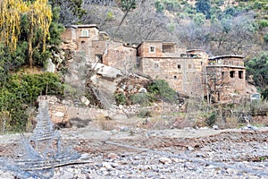 Berber village by river in Atlas mountains, Morocco