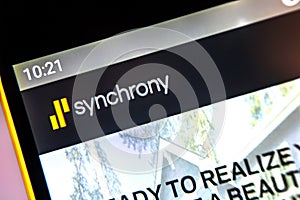 Berdyansk, Ukraine - April 1, 2019: Synchrony Financial website homepage. Synchrony Financial logo visible on the phone